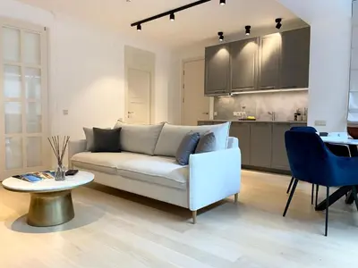 a living room with a couch and a table and a kitchen at Vilnius Apartments & Suites - Town Hall in Vilnius