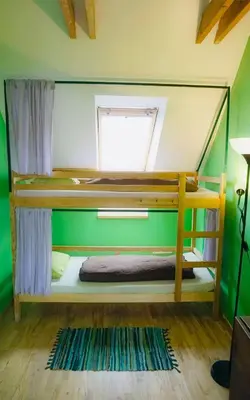 a bunk bed in a room with a window at Jimmy Jumps House in Vilnius