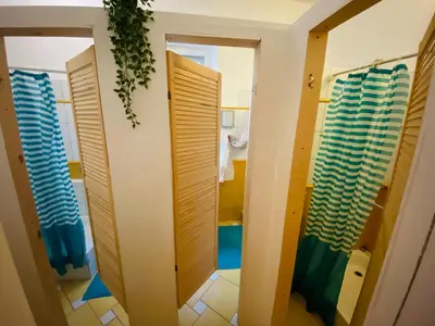 a bathroom with two doors and a mirror at Jimmy Jumps House in Vilnius