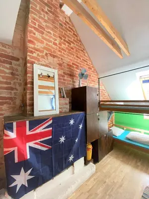a room with an american flag on a brick wall at Jimmy Jumps House in Vilnius