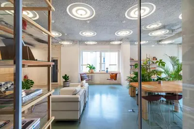 an office with a couch and a table with plants at Tech Spa Coliving&Coworking Spaces in Druskininkai