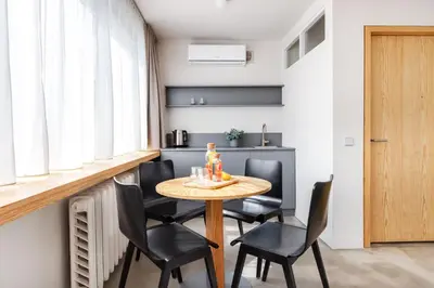 a small dining room with a table and chairs at Tech Spa Coliving&Coworking Spaces in Druskininkai