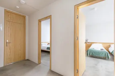 a bedroom with a door leading to a bed at Tech Spa Coliving&Coworking Spaces in Druskininkai