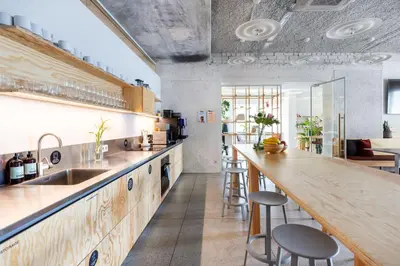 a kitchen with a counter and some stools in it at Tech Spa Coliving&Coworking Spaces in Druskininkai