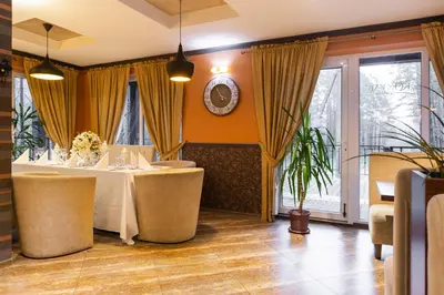 a dining room with a table and chairs at Vila Kelmyne in Molėtai