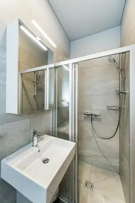 a bathroom with a sink and a shower at River city apartments in Kaunas