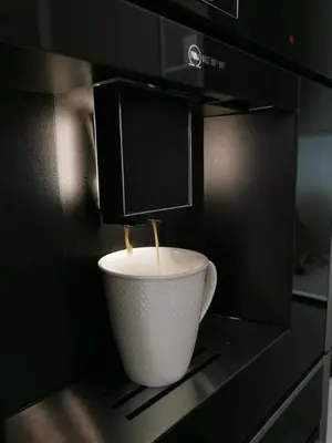 a cup of coffee sitting in a microwave at MyCasa CBD in Vilnius