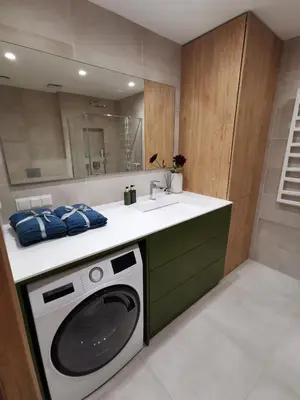 a kitchen with a washing machine and a sink at MyCasa CBD in Vilnius