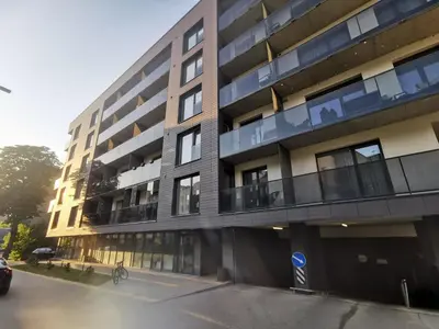 an apartment building with a car parked in front of it at MyCasa CBD in Vilnius
