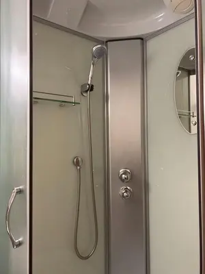 a shower with a shower head in a bathroom at Palūšės Kempingas (kambariai) in Palūšė