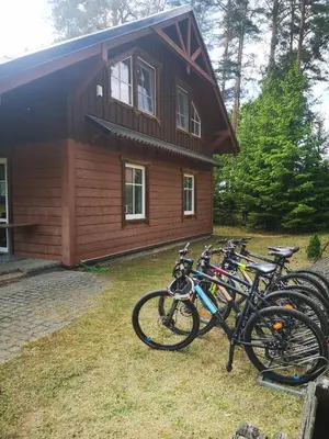 a group of bikes parked in front of a house at Palūšės Kempingas (kambariai) in Palūšė