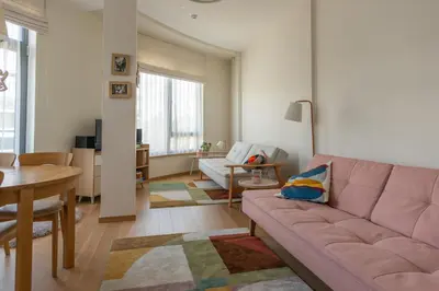 a living room with a pink couch and a table at 39DO in Druskininkai