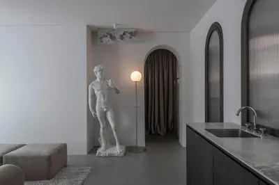 a statue of a man in a kitchen with a sink at Bōheme House in Kaunas