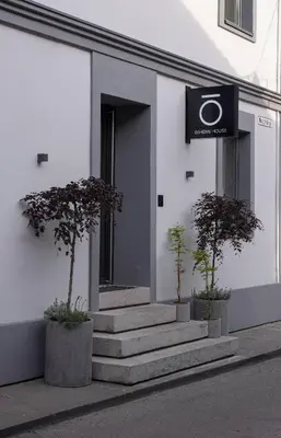 a building with stairs and a sign on it at Bōheme House in Kaunas