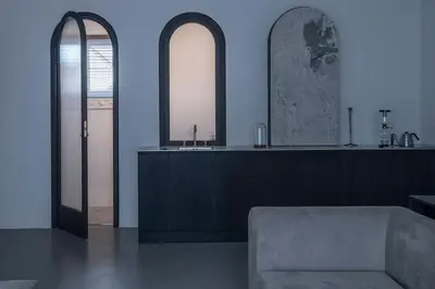 a living room with two mirrors and a couch at Bōheme House in Kaunas