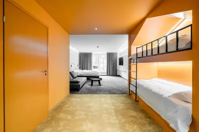 a bedroom with two bunk beds and a couch at ESE HOTEL in Birštonas