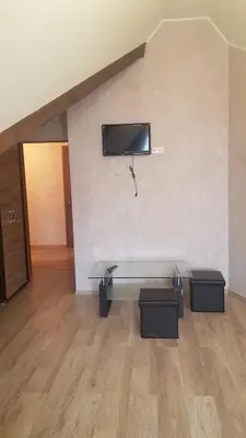 a room with a tv on a wall with a bench at Meldynas in Vabalninkas