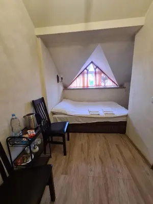 a small room with a bed and a window at Meldynas in Vabalninkas