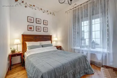 a bedroom with a bed and a window at Old Town Saviciaus street Apartment in Vilnius