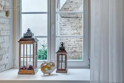 three lanterns sitting on a table in front of a window at Old Town Saviciaus street Apartment in Vilnius