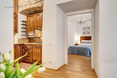 a kitchen and a bedroom with a bed in a room at Old Town Saviciaus street Apartment in Vilnius