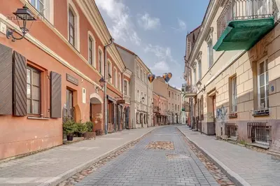 an empty street in an old town with buildings at Old Town Saviciaus street Apartment in Vilnius