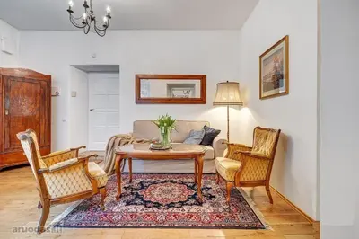 a living room with a table and chairs at Old Town Saviciaus street Apartment in Vilnius