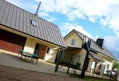a house with a bench in front of it at Pirtis Prie Neries Jonava in Jonava