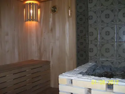 a room with a bed and a chandelier at Pirtis Prie Neries Jonava in Jonava