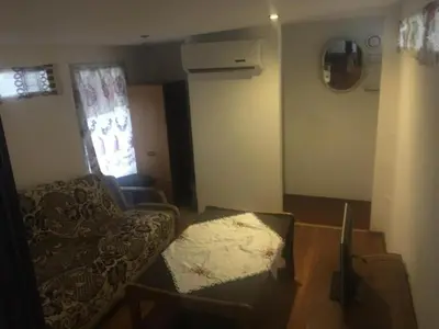 a living room with a couch and a chair at Pirtis Prie Neries Jonava in Jonava