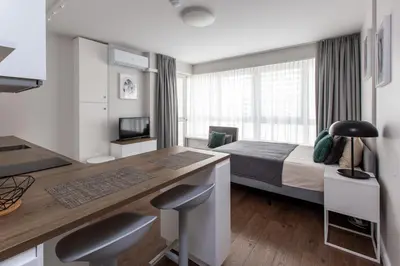 a hotel room with a bed and a desk with a desk at Studio Ligita near Egle in Druskininkai