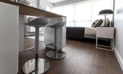 a room with a bedroom with a bed and a desk at Studio Ligita near Egle in Druskininkai