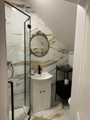 a bathroom with a sink and a mirror at Domus Fortuna in Vilnius