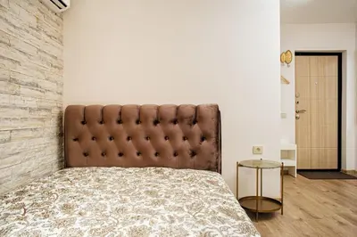 a bedroom with a large bed and a brick wall at RBRoom in Vilnius