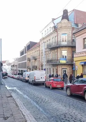 a street with cars parked on the side of the road at RBRoom in Vilnius