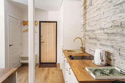 a kitchen with a counter and a brick wall at RBRoom in Vilnius