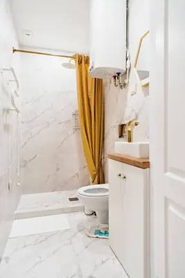 a white bathroom with a toilet and a shower at RBRoom in Vilnius