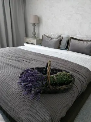 a basket of flowers sitting on a bed at Naktakės apartamentai in Kupiškis