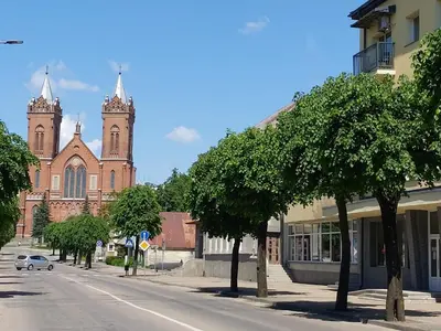 an empty street in front of a large church at Naktakės apartamentai in Kupiškis