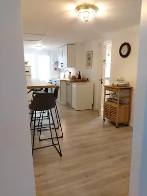 a kitchen with a table and chairs in a room at Naktakės apartamentai in Kupiškis