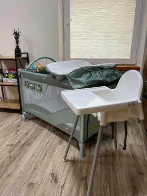 a hospital bed with a table in a room at V15 Apartment in Druskininkai