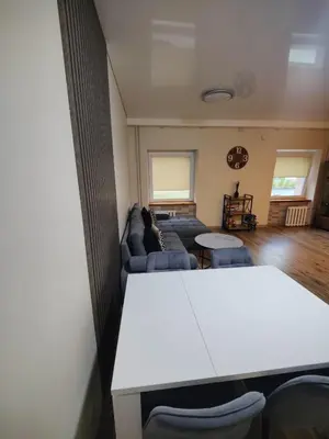 a living room with a couch and a table at V15 Apartment in Druskininkai