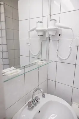 a bathroom with a sink and a mirror at Motelis Gariūnai in Vilnius