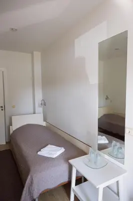 a hotel room with a bed and a mirror at Motelis Gariūnai in Vilnius