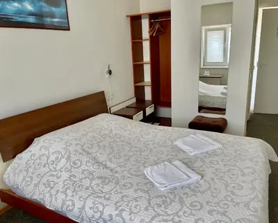 a bedroom with a bed with two towels on it at Motelis Gariūnai in Vilnius