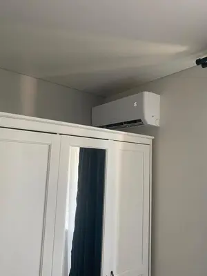 a microwave on top of a white cabinet at Nemuno apartamentai in Panevėžys