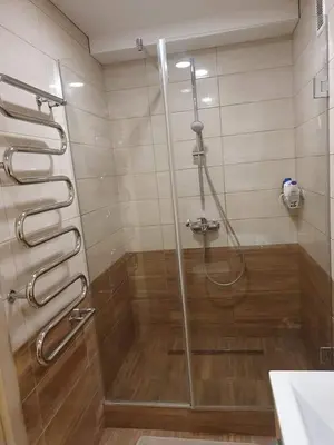 a shower with a glass door in a bathroom at Nemuno apartamentai in Panevėžys