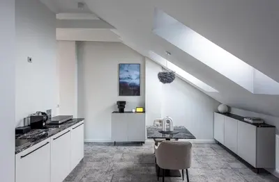 a kitchen with white cabinets and a table at Place No. 2 in Vilnius
