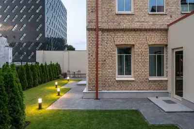 a garden with lights in the grass next to a building at Place No. 2 in Vilnius