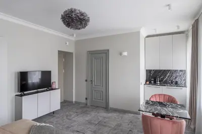 a living room with white walls and a tv at Place No. 2 in Vilnius
